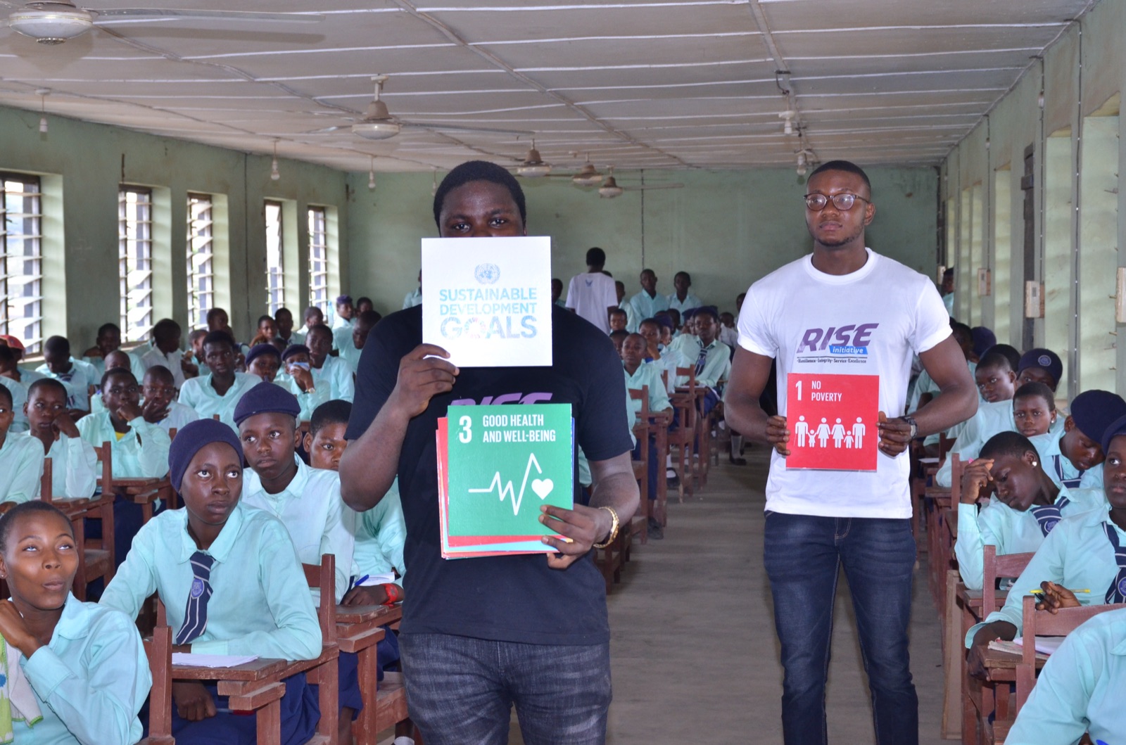 Students holding Sustainable Development Goals cards during a session